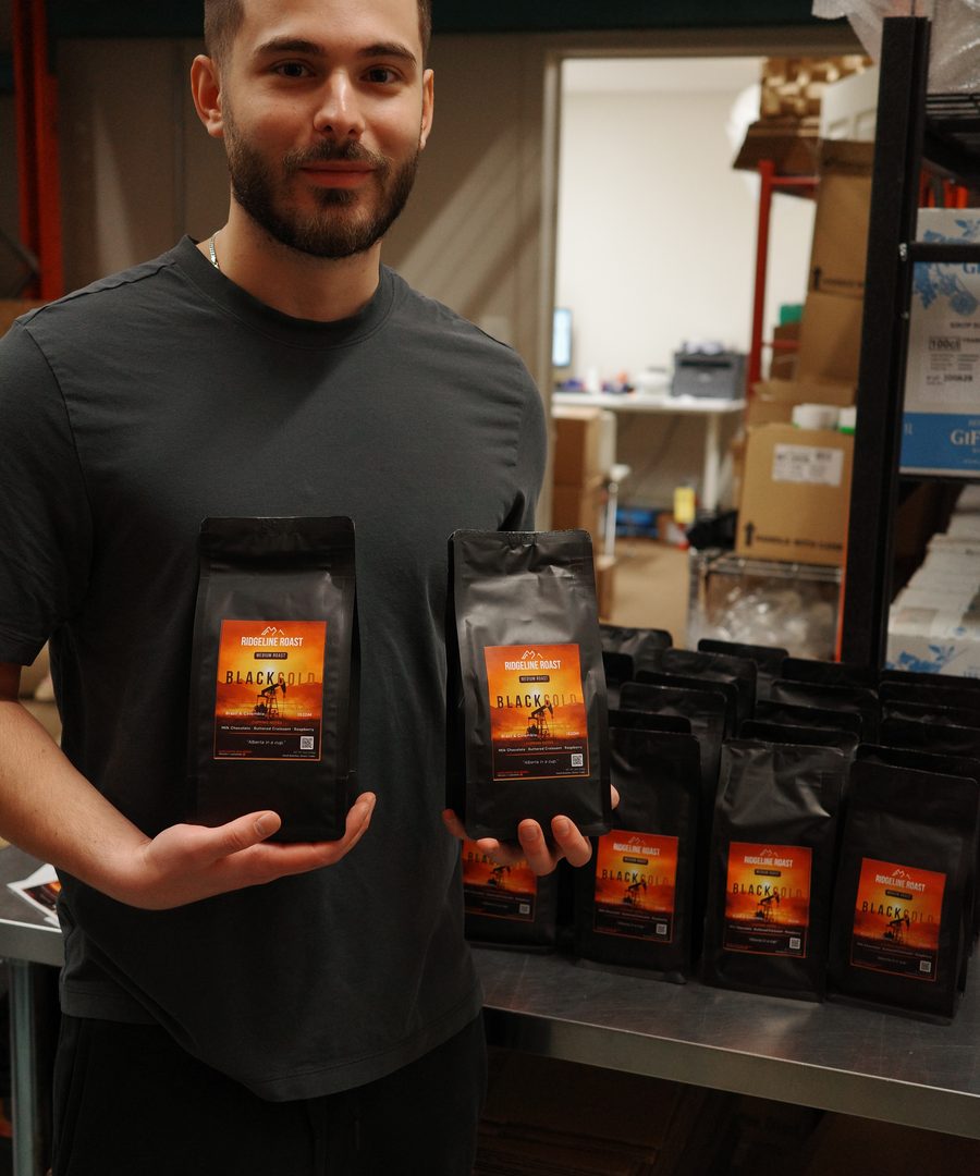 A Ridgeline Roast bag held up in front of a wholesale order at the warehouse